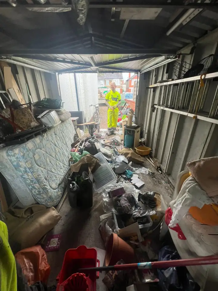 Cluttered garage being emptied by the TJB team