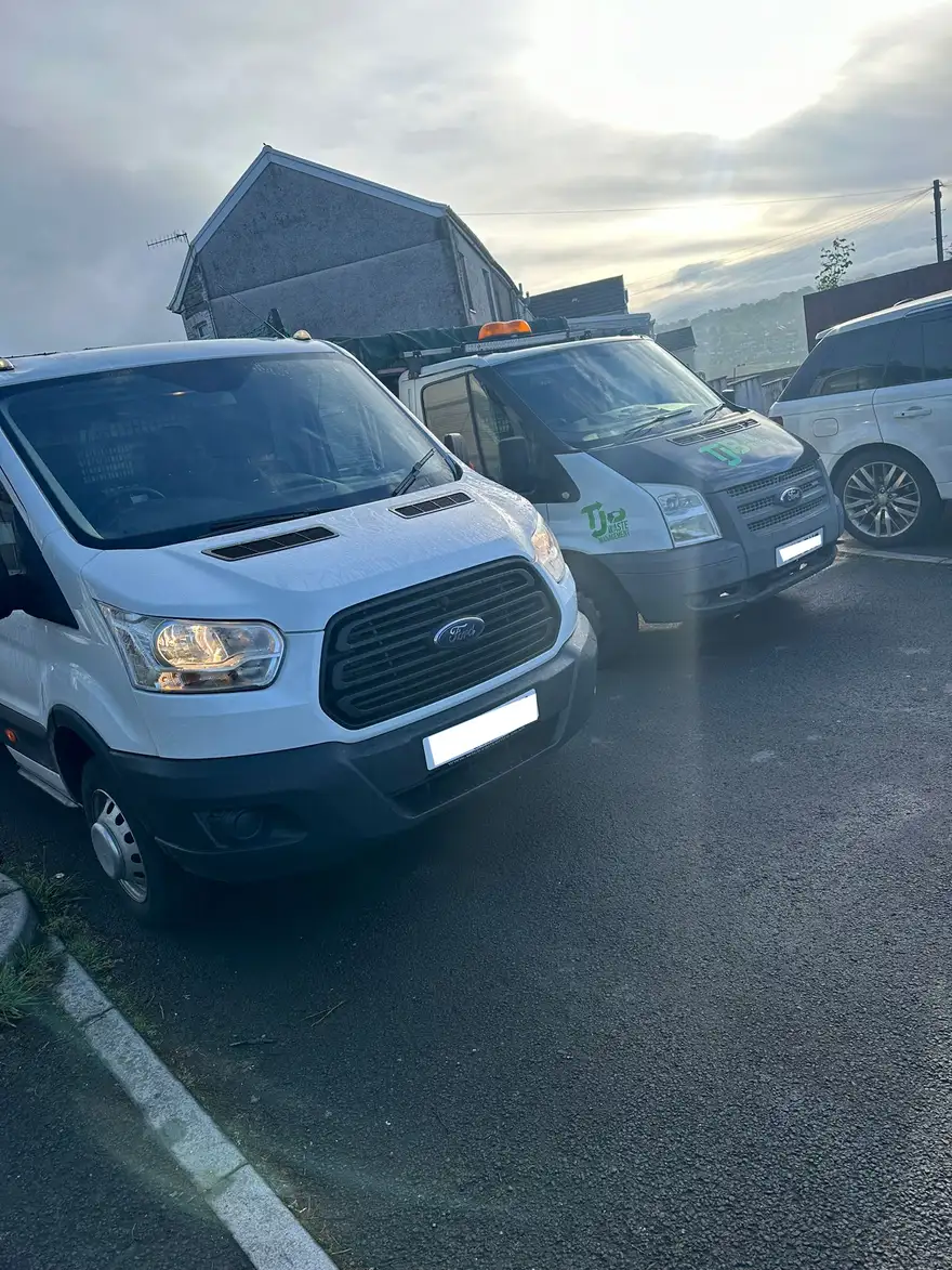 Two TJB Waste Management tipper vans parked up before a day of waste collections in South Wales
