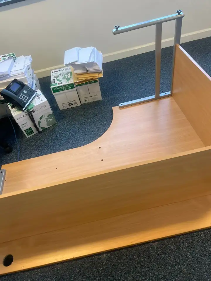 Curved office desk dismantled and ready to be cleared