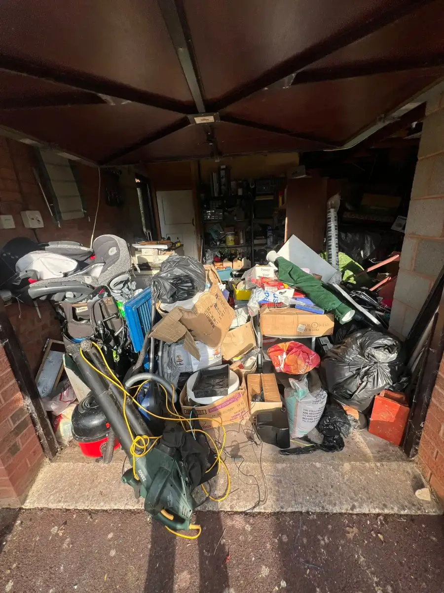 Garage filled with household items, tools and boxes before a clearance